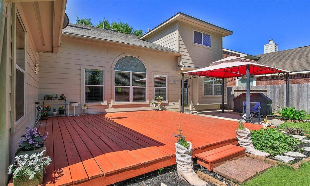 The expansive deck features a covered grilling area, perfect for outdoor entertaining.