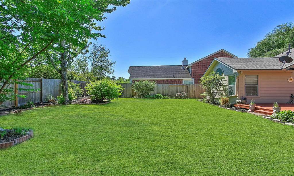 The backyard is beautifully maintained, offering a lush, inviting space for relaxation and entertainment.