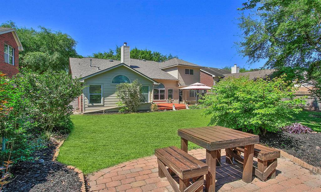 Enjoy your morning coffee in this serene backyard oasis.