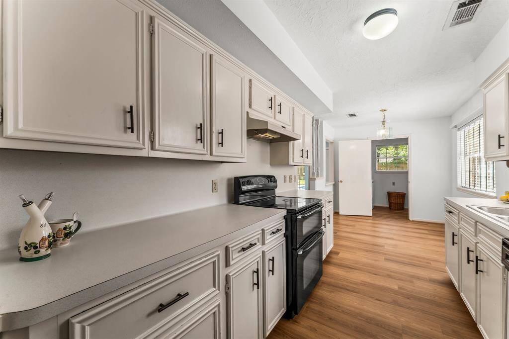 Lovely kitchen offers plenty of cabinet space.