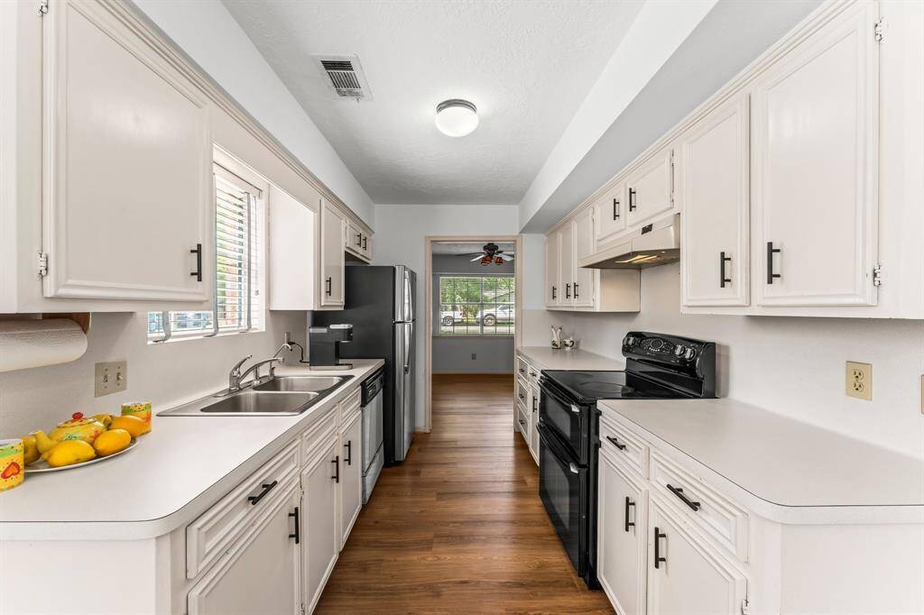 A double sided sink and charming window make doing dishes enjoyable!