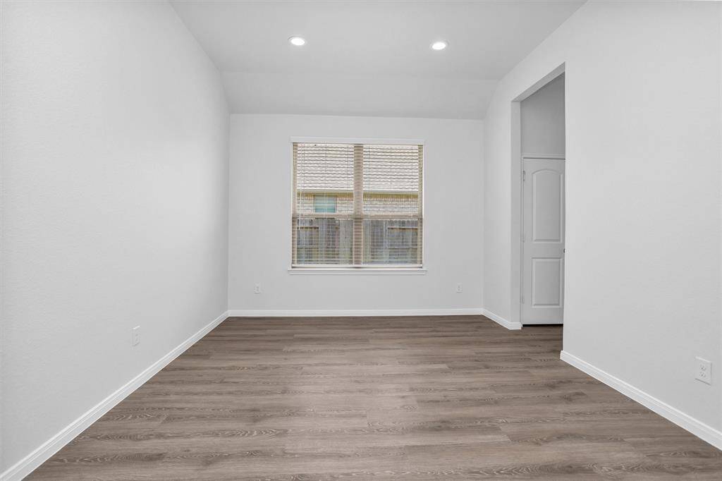 Versatile formal dining room just off the foyer can also serve as a game room, media room, or playroom. The neutral tones and open access to the kitchen create a seamless flow for entertaining.