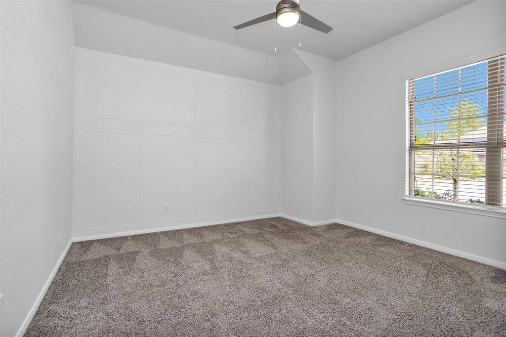 Three additional bedrooms offer comfortable spaces with ample closet storage and ceiling fans—ideal for kids, guests, or hobbies.