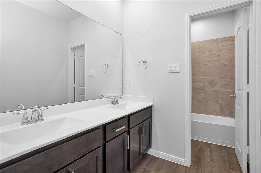 Shared full bathroom with modern fixtures and finishes, conveniently located between the secondary bedrooms.