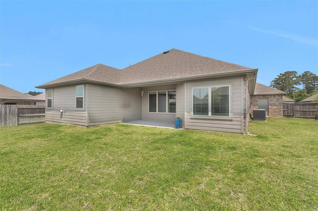 Step out to a covered patio perfect for year-round outdoor enjoyment. The space is ideal for grilling, relaxing, or watching kids and pets play in the yard.