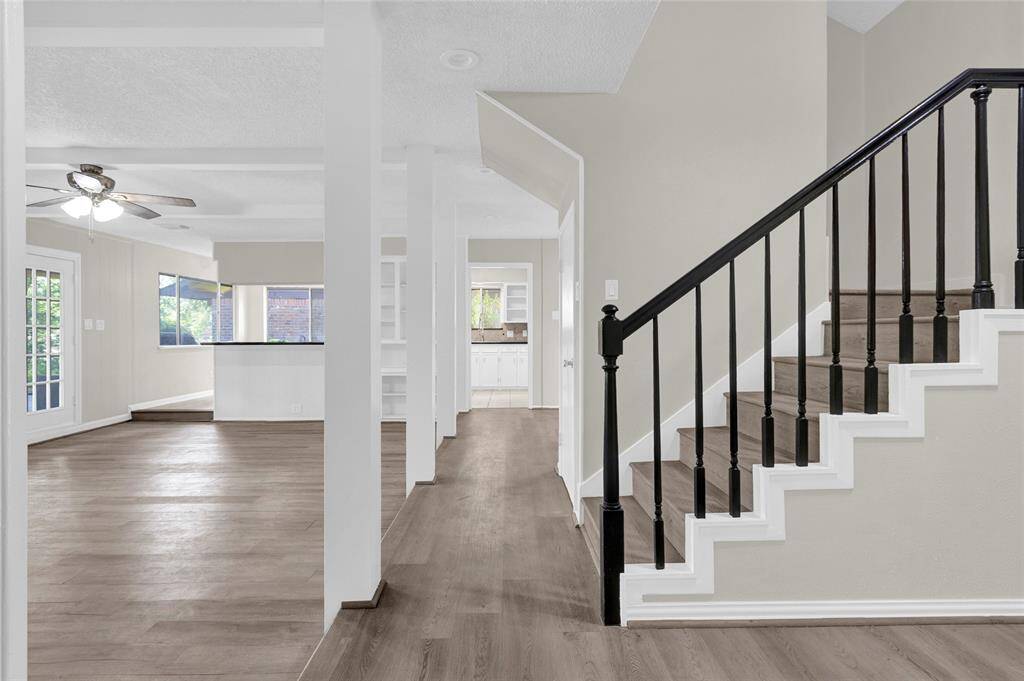 Clean lines, neutral tones, and open sightlines lead you directly into the main living area, creating an effortless flow throughout the first floor. The layout offers views into the spacious family room, kitchen, and breakfast nook, making it perfect for both daily living and entertaining.