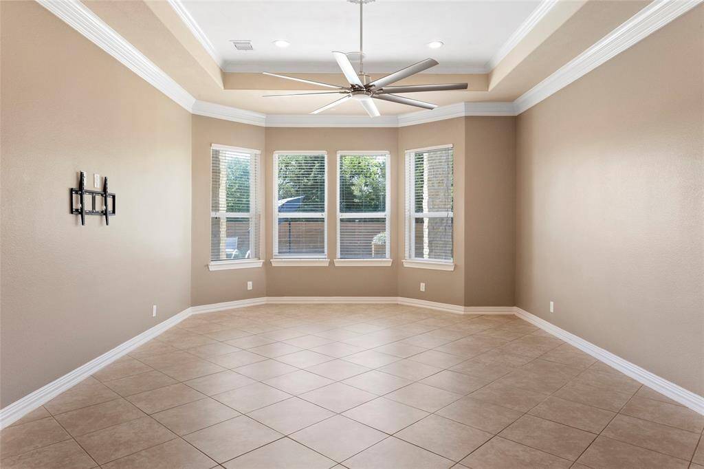 Bright and spacious Primary Bedroom with bay windows providing ample natural light and beautiful backyard views.