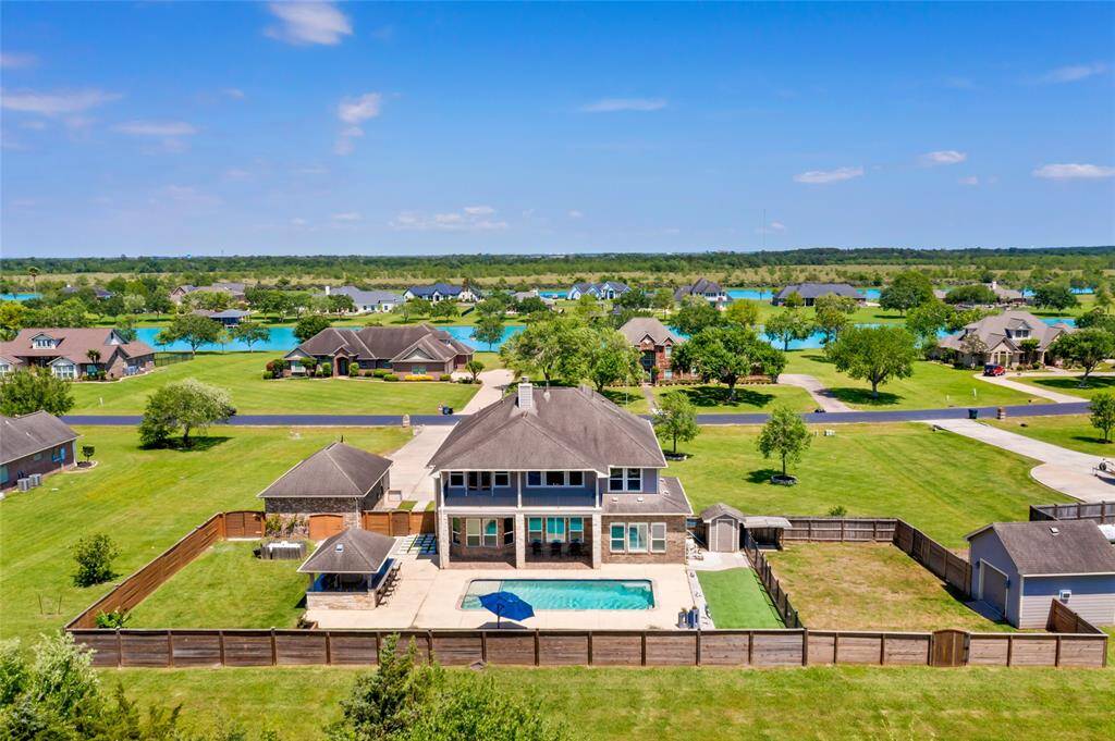 This spacious two-story home sits on a 1-acre lot with a large, fenced backyard, a pool and custom outdoor kitchen. The property offers a scenic, open view, ideal for enjoying outdoor activities and relaxation.