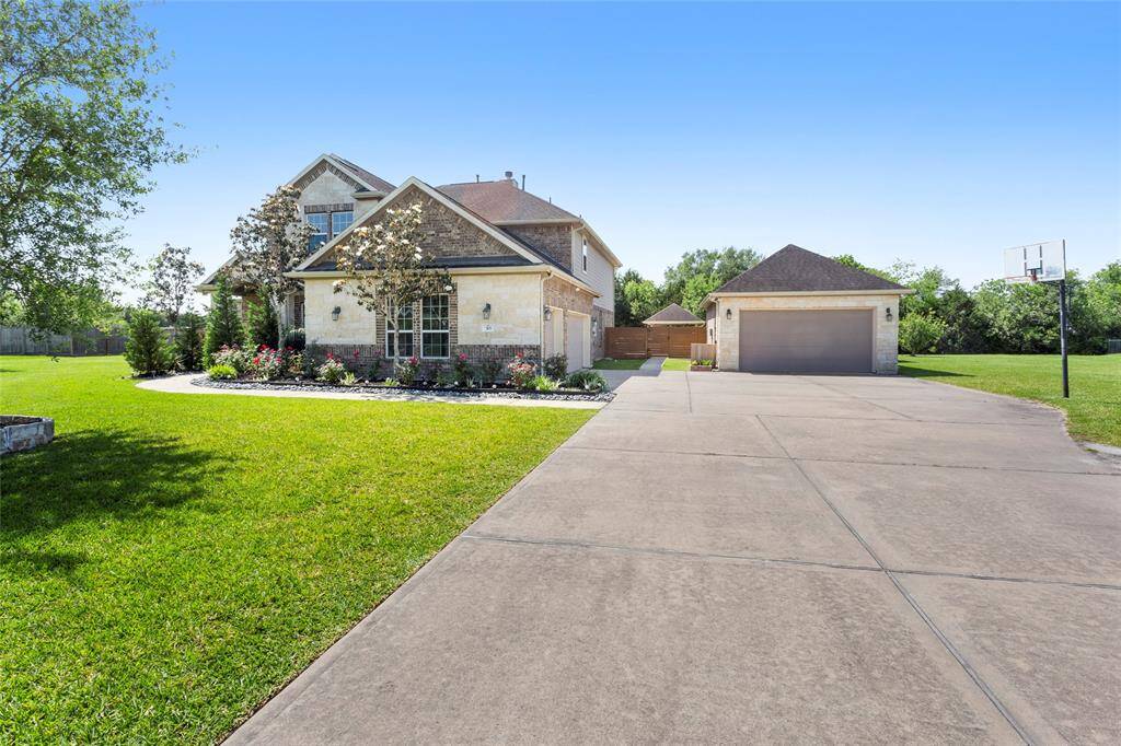 This charming home offers an extra wide driveway leading to a 3-car attached garage and a 2-car detached garage or workshop.