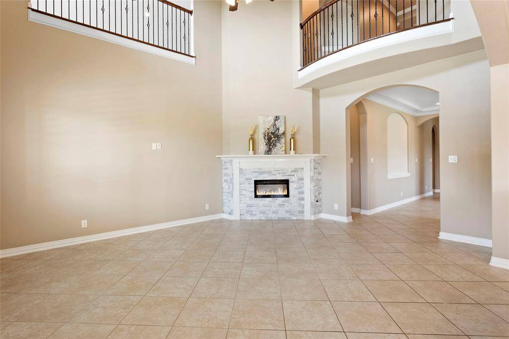 Open views to the upstairs, with elegant railings and arched entryways, creating a sophisticated and inviting atmosphere.