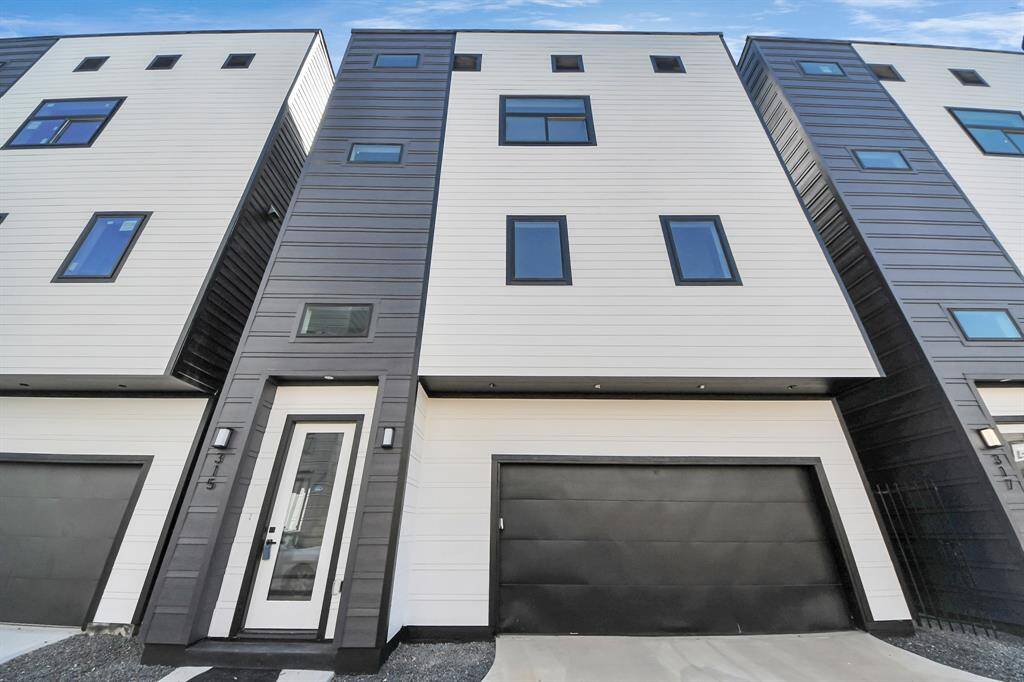 Welcome to 315 N Nagle Street! This sleek, modern home built by Tradewind East Court Development features a bold black exterior with Cemplank fiber cement siding and HardiePlank fascia, ensuring durability and style.