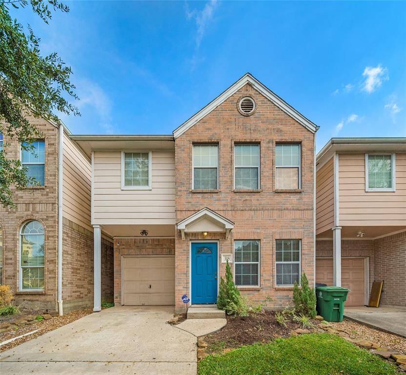 Charming two-story brick home with a welcoming blue front door. Features an attached garage and a small front yard with easy-to-maintain landscaping. Ideal for buyers seeking a cozy and low-maintenance property.