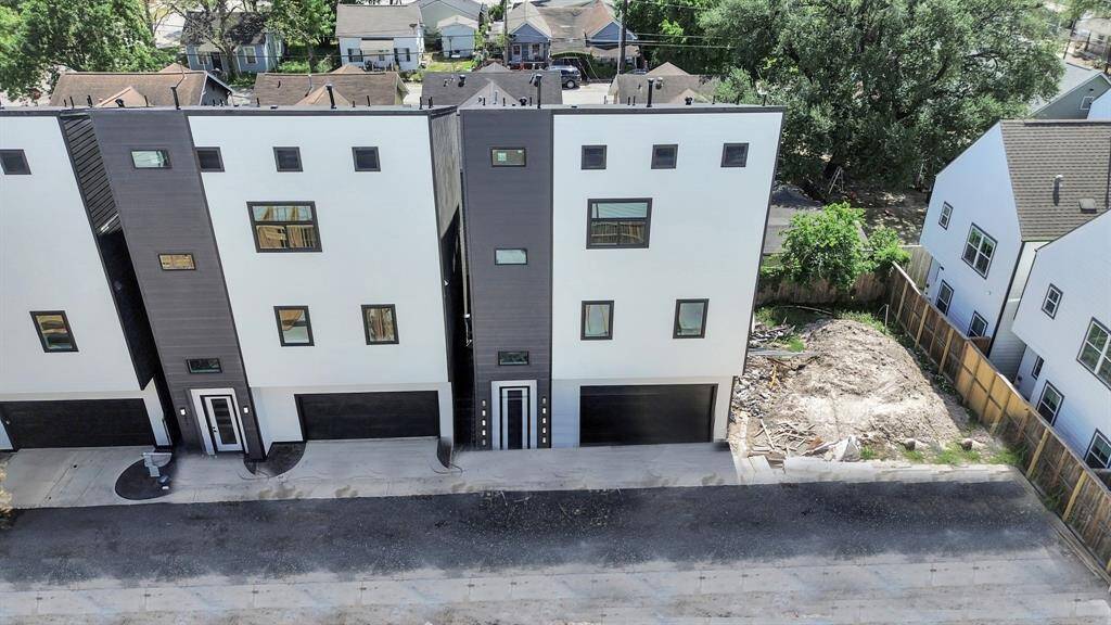 Welcome to 319 N Nagle Street! This sleek, modern home built by Tradewind East Court Development features a bold black exterior with Cemplank fiber cement siding and HardiePlank fascia, ensuring durability and style.