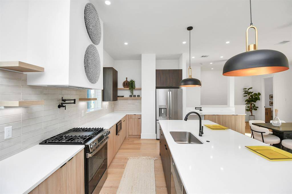 The kitchen is equipped with modern stainless steel appliances, ensuring both style and efficiency in cooking.