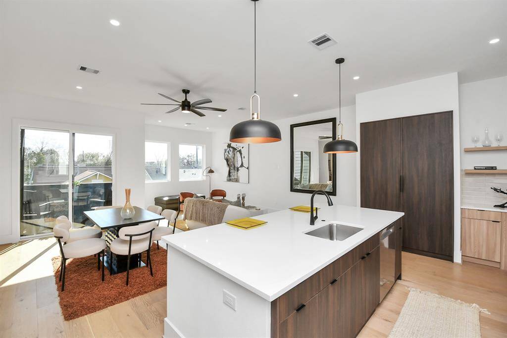 The open-concept design seamlessly connects the kitchen to the dining area and living room area.