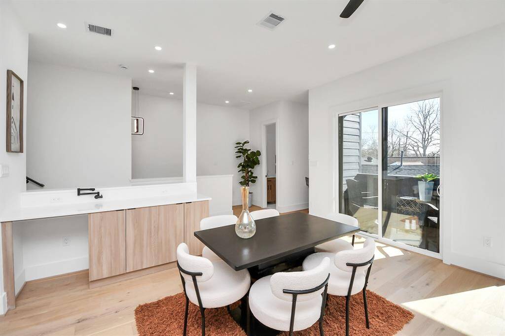 Large sliding glass doors lead to a private balcony, allowing for natural light and an easy transition to outdoor living.