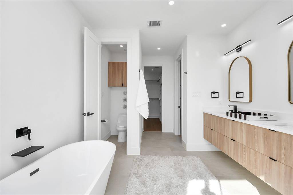 Unwind in the freestanding acrylic tub, designed for ultimate relaxation.