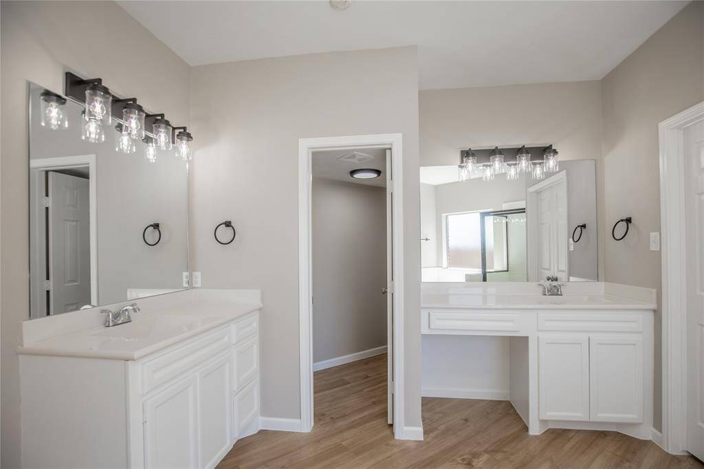 Master Bathroom suite with double sinks, water closet, and linen closet.