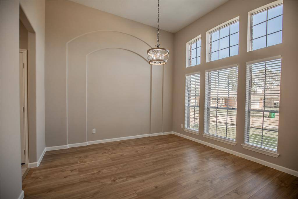 Dining Room has high ceiling, accent wall and lots of natural light.