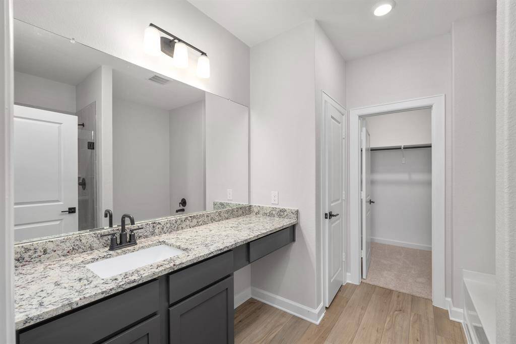 The primary bathroom is a dream! From granite countertops to built in vanity seating area, tiled shower and separate soaking tub, with a watercloset for privacy, this bathroom has it all.