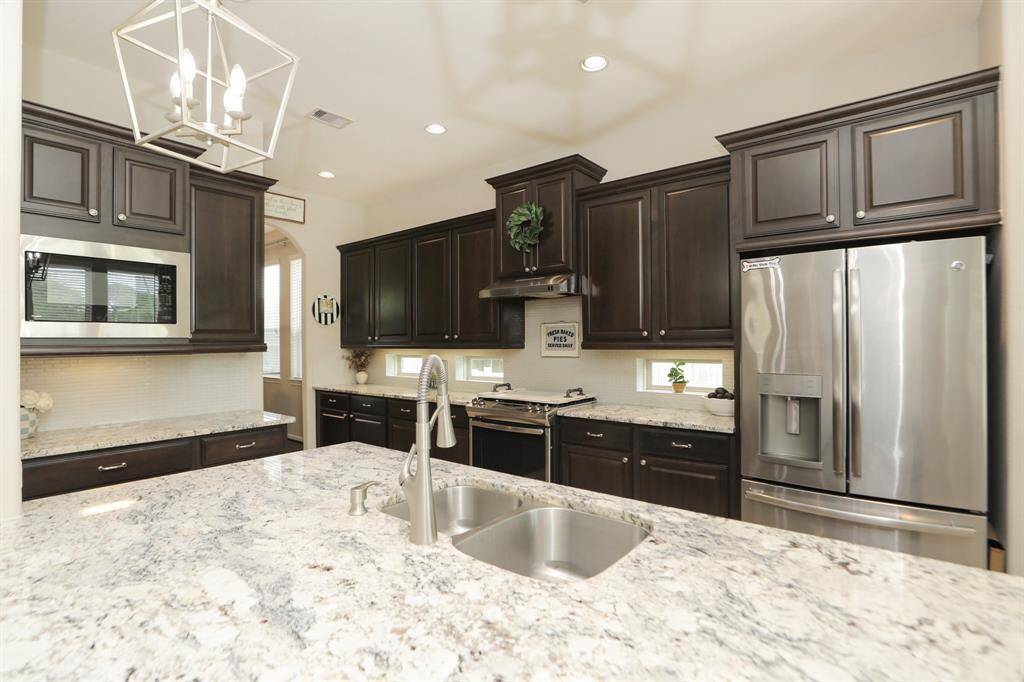 Island has space, space, space with kitchen sink and lovely granite countertops.
