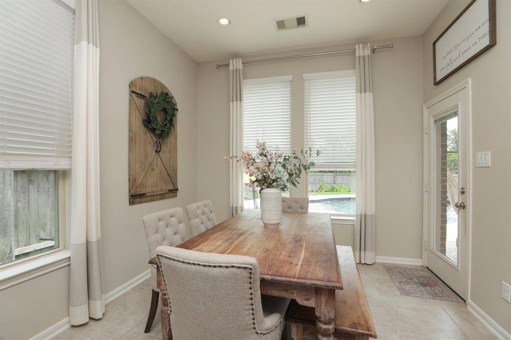 Breakfast area with a door to the patio, pool and yard.