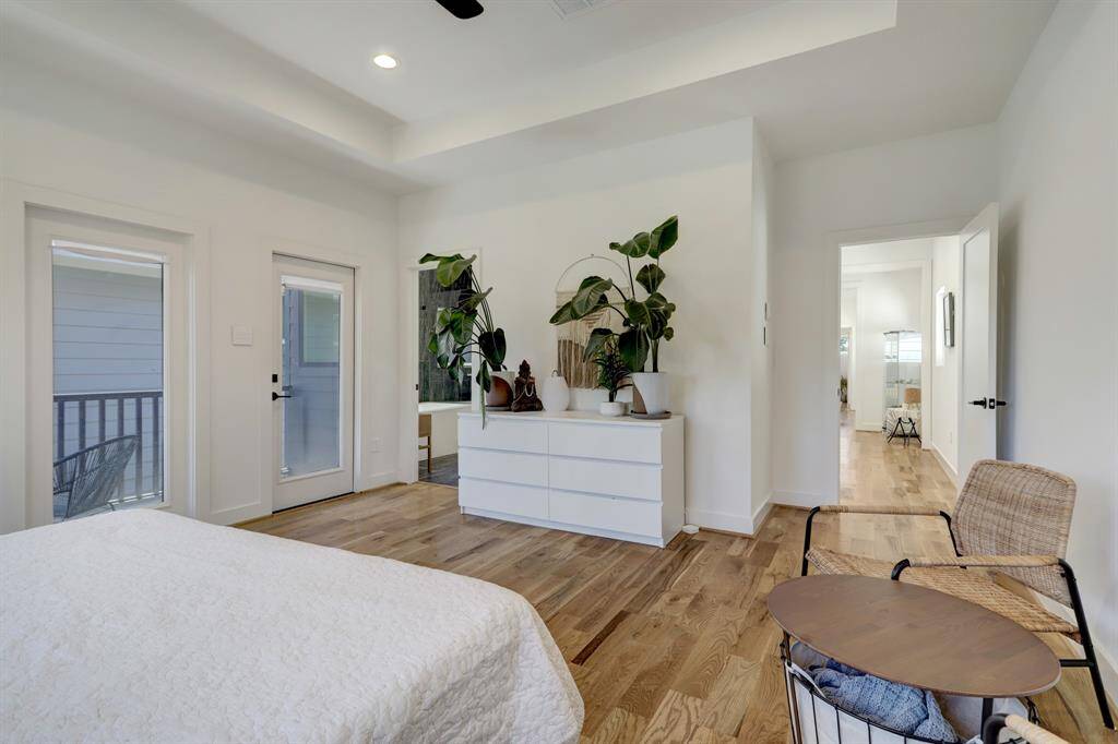 Another view of primary bedroom which has a private balcony.