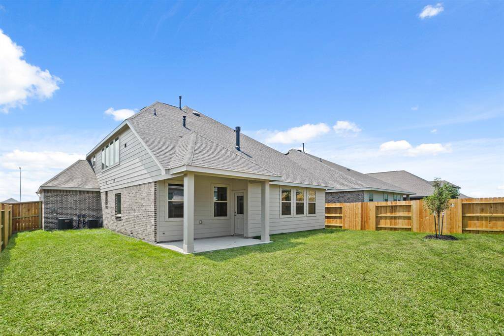 Enjoy outdoor living in this backyard with a covered patio