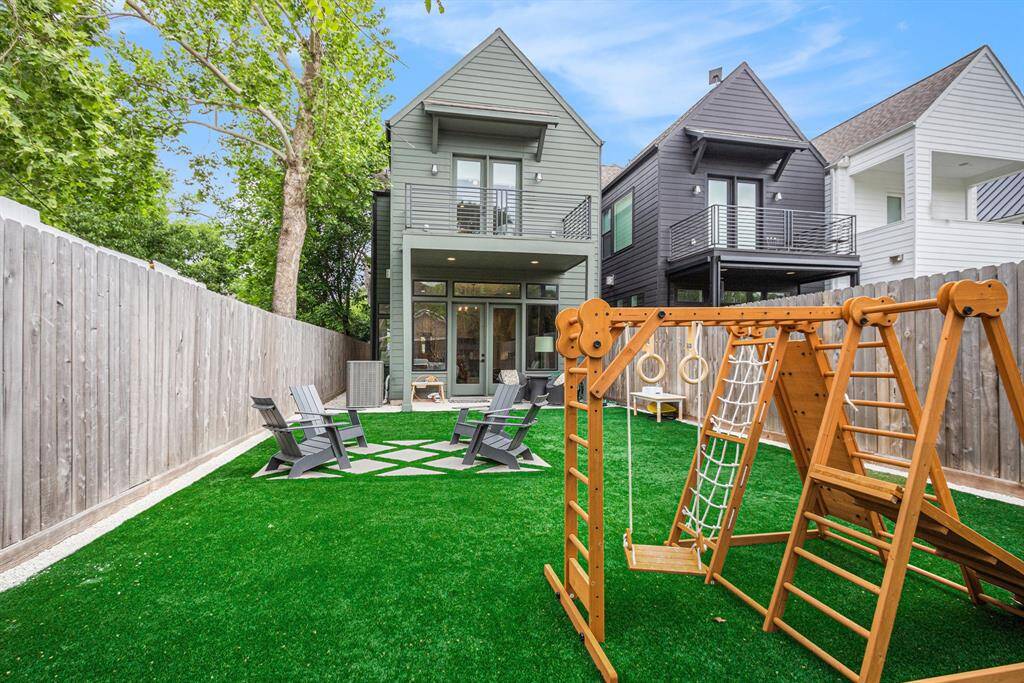Backyard features professionally installed turf — perfect for play, pets, or relaxing outdoors