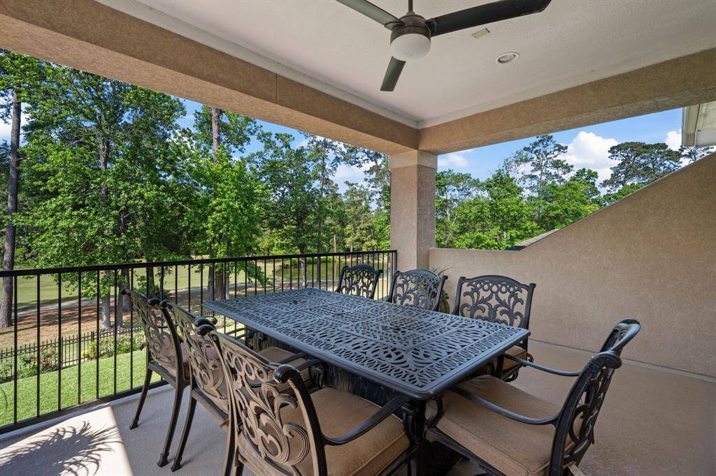 Enjoy serene views and fresh air from the expansive second-floor balcony, perfect for outdoor dining or relaxing under the breeze of the ceiling fan. Overlooking lush greenery and the golf course beyond, this peaceful retreat is ideal for morning coffee or evening gatherings.