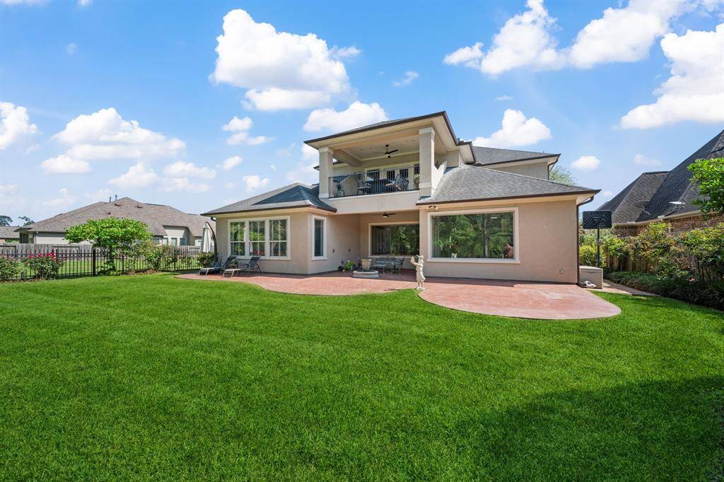This beautifully maintained backyard offers ample green space, dual covered patios, and an upper-level balcony—perfect for entertaining or relaxing outdoors. With mature landscaping and room to play or garden, this private oasis is ideal for enjoying sunny Texas days.