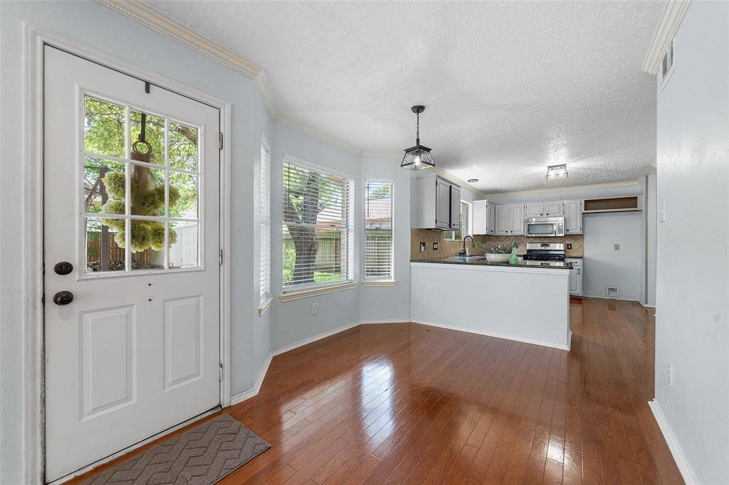 Kitchen opens up and flows over the peninsula countertop to the dining area