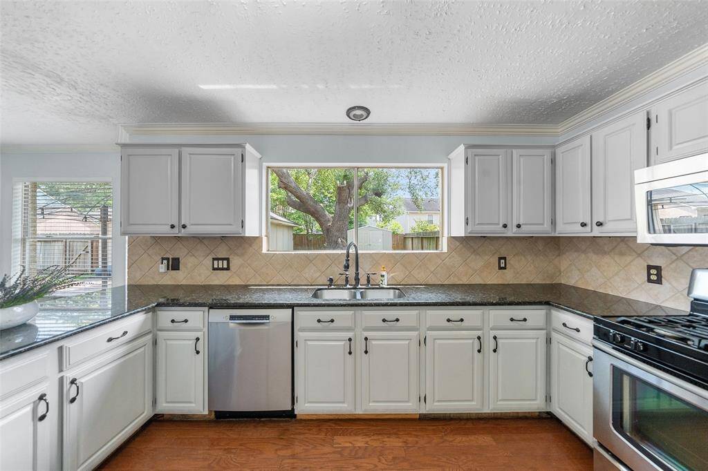 Fantastic kitchen with plenty of beautiful granite countertop and cabinet space.