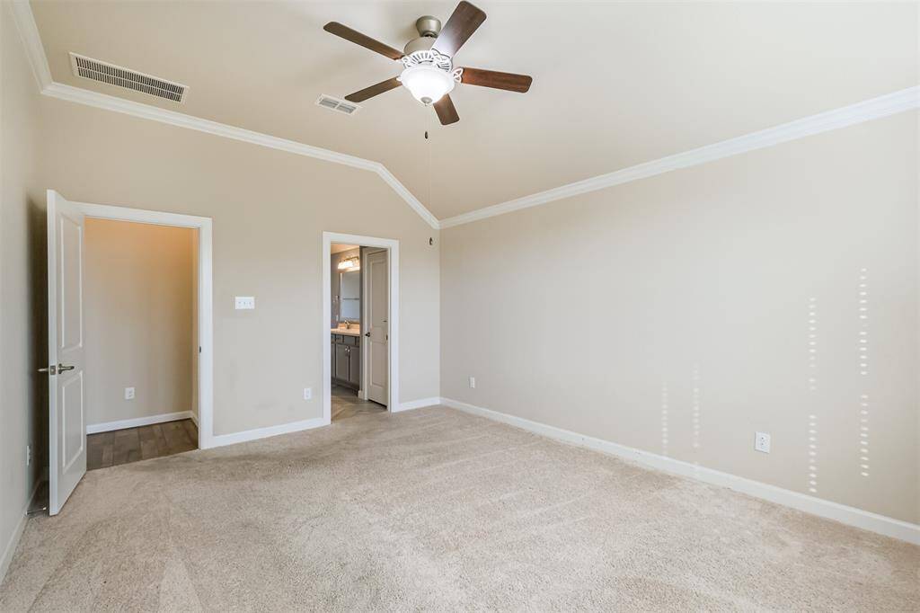 This primary owner's suite has access to an en-suite bathroom and a closet, with ample natural light from the window.