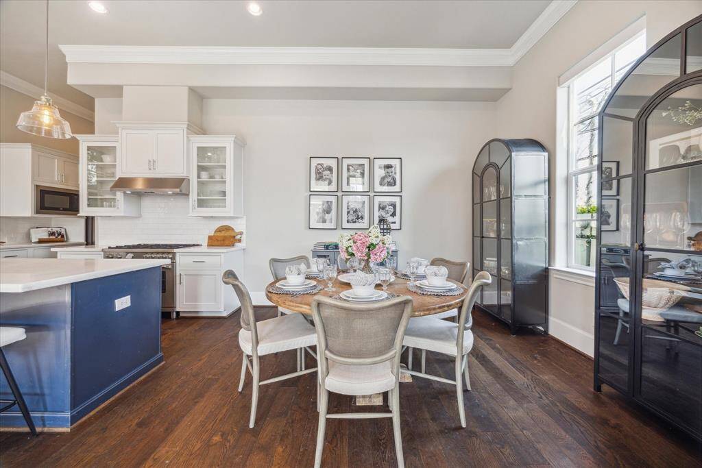 Crown molding accentuates the 12 ft ceilings on the first floor.  Note that this table seats 6 and there are two large display cabinets flanking the window -- plenty of room for it all.