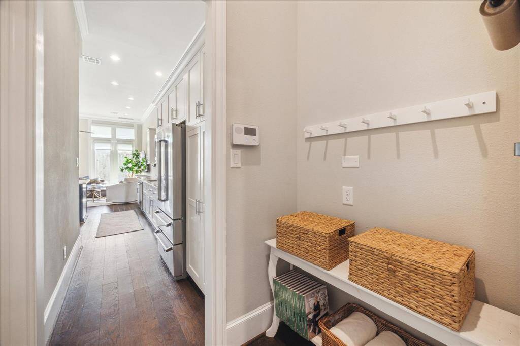 Opposite the garage entry door is this mud room area -- compact but it works well and saves space -- pegs on the wall -- just add a table type of your choice and voila! Mudroom!
