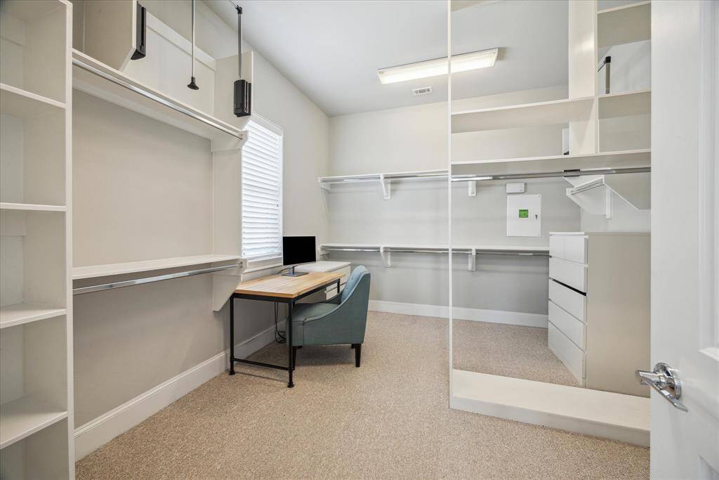 Primary closet features many built-ins and it is arranged so 2 can share it.  It can house a small workspace too!