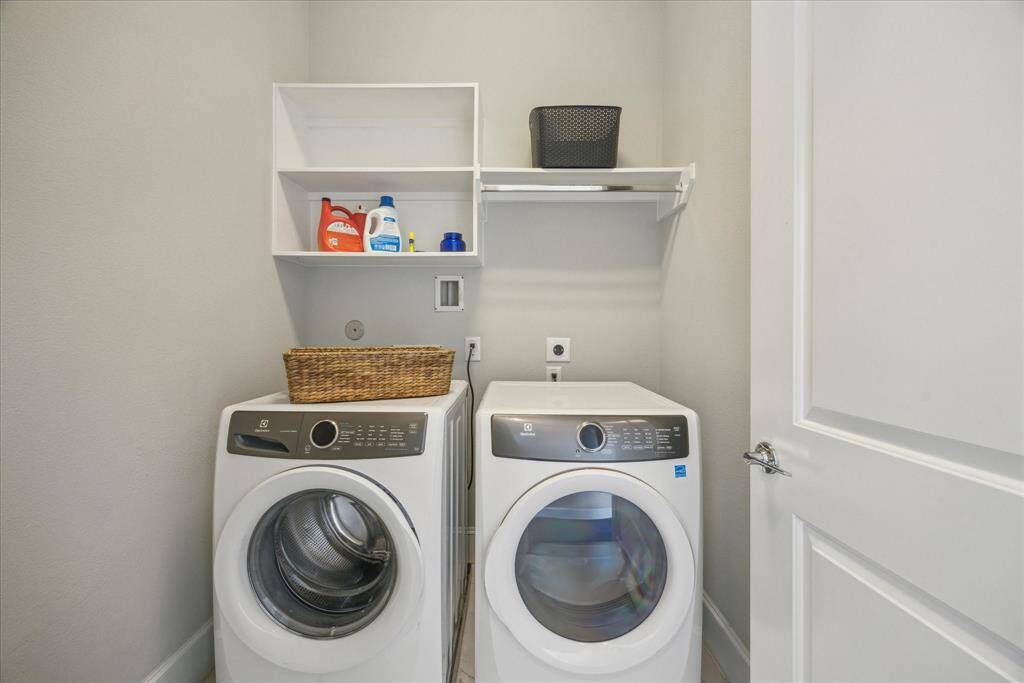 Laundry room is deep and has a rod and shelves -- we all know how important the little things are when doing laundry -- it's right here.