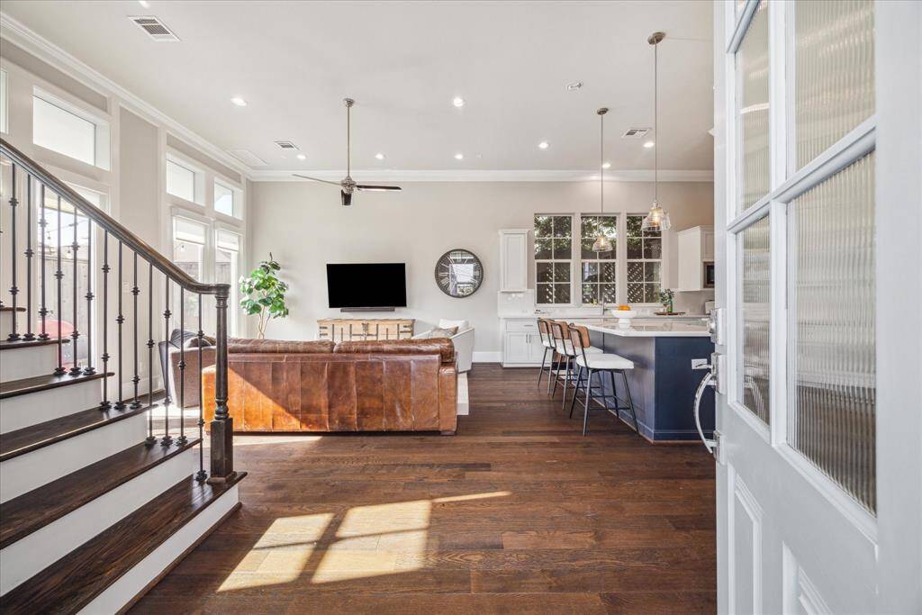 Living area is spacious -- and look at the light pouring in!  12-foot ceilings and beautiful Hickory wood floors.