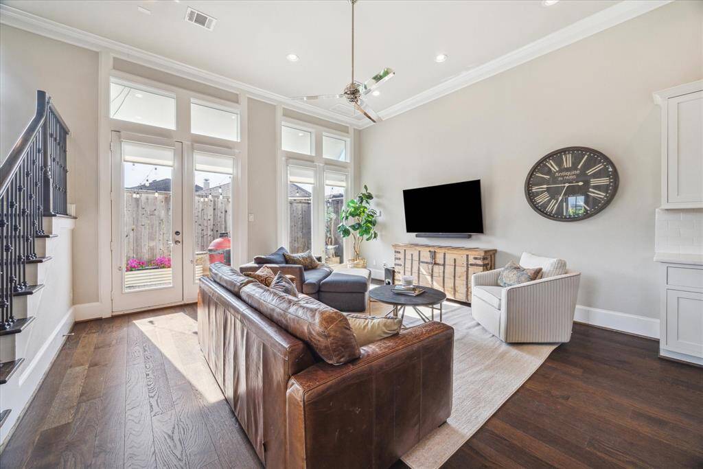Well-placed lighting and a contemporary ceiling fan. This room just flows easily into the back yard patio.