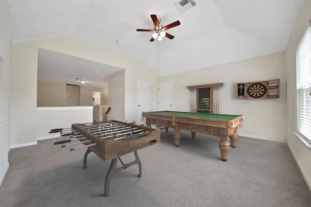 View of game room, virtually staged.