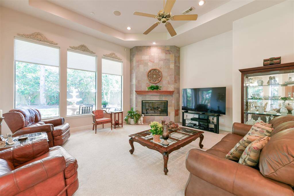 Living room with large windows and tiled fireplace to relax and unwind after a long day