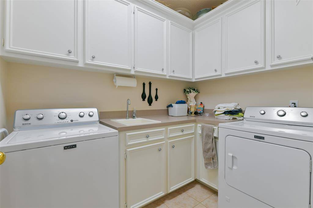 Laundry room with additional cabinet space and sink