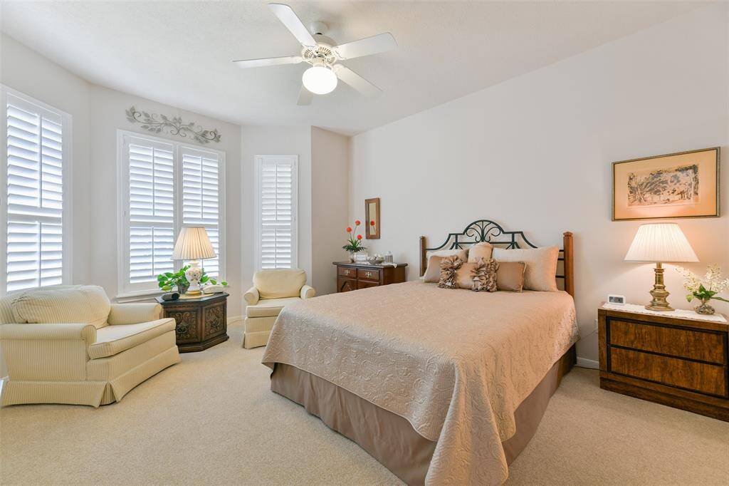 1st bedroom with plantation shutters on windows. This spacious bedroom has it's own private bathroom.