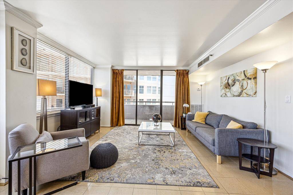 A floor-to-ceiling sliding glass door in the living room opens to a covered balcony, perfect for outdoor relaxation.