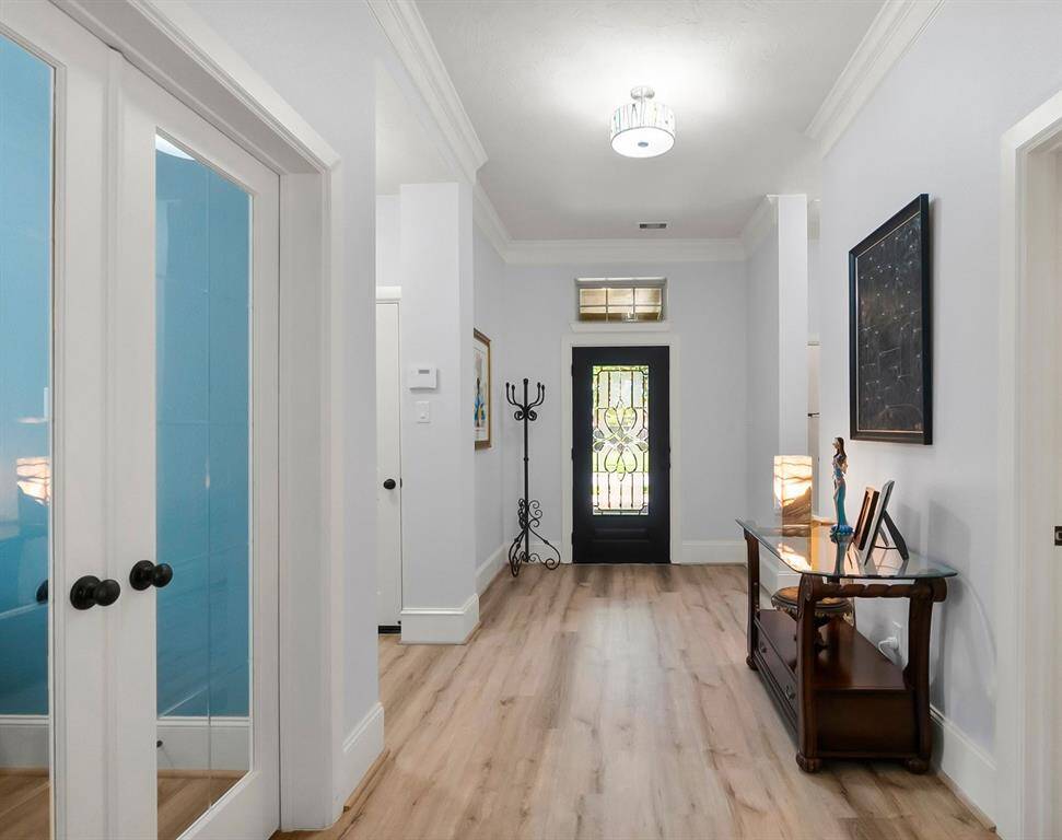 hallway looking to front door, study on the left