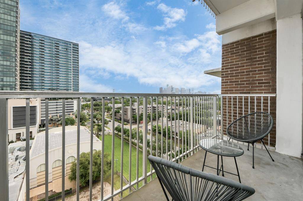 The view from the balcony—panoramic Downtown Houston skyline, day and night.