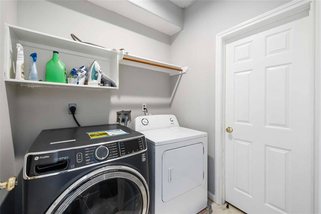 A well-organized laundry room, featuring a modern washer and dryer.