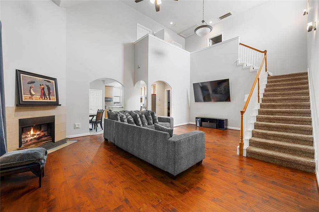 The warmth of a crackling fire, the comfort of a plush couch, and the elegance of high ceilings. This living room has it all!