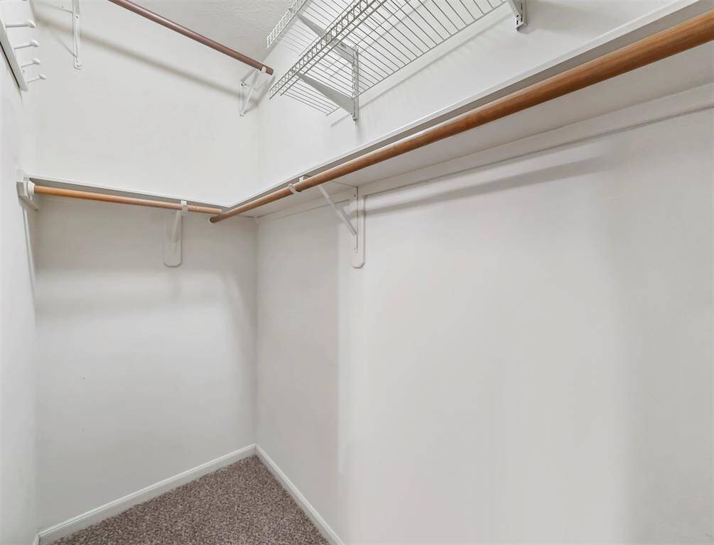 A well-lit, spacious walk-in closet.